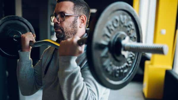 man-with-glasses-doing-bicep-curl-with-bar